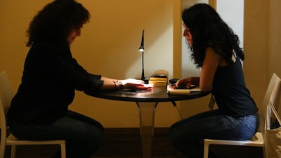 Annabel Daou conducts a silent fortune telling session in an art installation called Fortune at Art Dubai 2014. Image by Pawan Shinh / The National