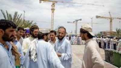 People wait in a queue at the Emirates Identity Authority office in Abu Dhabi yesterday to apply for their new ID cards.