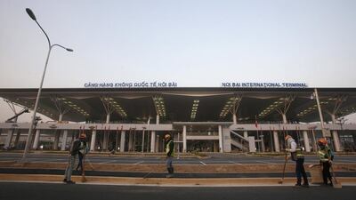 Workers sweep the road of the new terminal at Noi Bai international airport in Hanoi. The four-storey facility has been built since December 2011 by a workforce of 1,300 people. Kham / Reuters