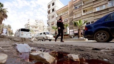 A Syrian man walks past a pool of blood following shelling in the Jaramana southeastern district of Damascus. Louai Beshara / AFP Photo