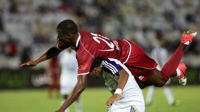 Al Wahda's Papa Waigo and Fawzi Fayez of Al Ain clash at Tahnoun Bin Mohammed Stadium. Pawan Singh / The National