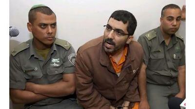 The Gazan engineer Dirar Abu Sisi, centre, who disappeared while travelling on a train in Ukraine last month, talks to the press at the Petah Tikvah magistrates court for a hearing to set the date for his indictment.