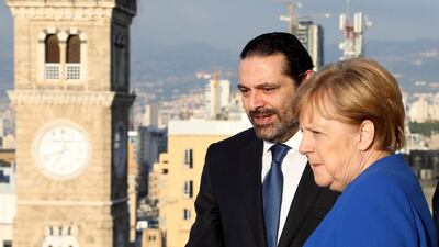 Lebanese prime minister-designate Saad Hariri stands with German Chancellor Angela Merkel at the government palace in Beirut on June 21, 2018. Dalati Nohra / Handout via Reuters