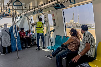 Passengers ride aboard the new Cairo Monorail as it approaches al-Fattah al-Aleem Grand Mosque in the New Administration Capital (NAC) megaproject, some 45 kilometres east of Cairo. AFP