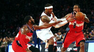 New York Knicks’ Carmelo Anthony, centre, tries to split Washington Wizards defenders during a loss on Christmas Day. Jeff Zelevansky / AFP