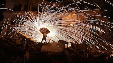 A displaced Palestinian plays with fireworks after breaking his Ramadan fast in Jabalia refugee camp in the northern Gaza Strip. AFP