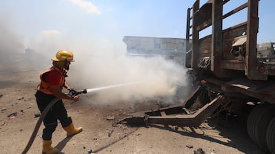 A firefighter tries to extinguish the flames of a burning lorry in Maghazi, in the central Gaza Strip. AFP
