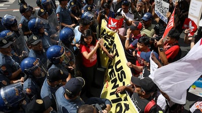 Activists clash with anti-riot police during a demonstration in front of the US Embassy in Manila, Philippines. EPA