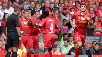 Arsene Wenger does not believe he needs to make public Arsenal's offer for Luis Suarez, right. Lindsey Parnaby / AFP