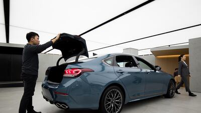 A customer inspects a Hyundai Genesis G80 Sport at the newly opened Genesis showroom in the Gangnam district in Seoul, South Korea. SeongJoon Cho/Bloomberg