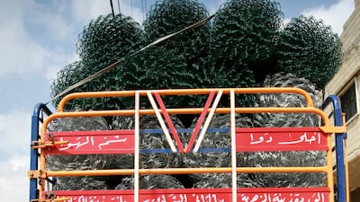 Artist Ali Younis has hand-painted hundreds of trucks with designs such as calligraphy. Courtesy Falak Shawwa