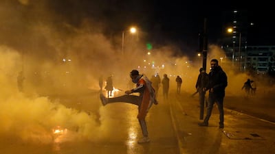 An anti-government demonstrator kicks a tear gas canister that was fired by Lebanese riot police in Beirut. AP Photo