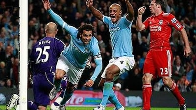 City's Carlos Tevez celebrates scoring his first goal against Liverpool in Manchester, northern England.