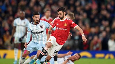 Manchester United's midfielder Bruno Fernandes controls the ball as West Ham United's midfielder Manuel Lanzini closes in. AFP