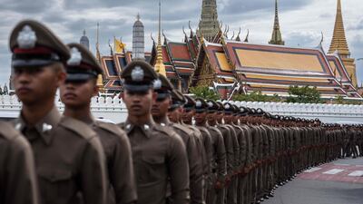 Thai police line up in front of the Grand Palace ahead of the arrival of the royal motorcade in Bangkok, as the body of Thailand's former queen Sirikits' body is transported to the Grand Palace for the start of funeral rites. AFP