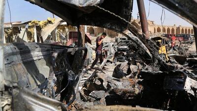 Debris is scattered at the site of a Friday night suicide car bombing at a busy market in Khan Bani Saad in the Diyala province, about 30 kilometers northeast of Baghdad on July 18. AP