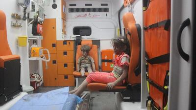 Five-year-old Omran Daqneesh, with his face bloodied, sits with his sister inside an ambulance after they were rescued following an air strike in the rebel-held Al Qaterji neighbourhood of Aleppo, Syria on August 17, 2016. Mahmoud Rslan/Reuters