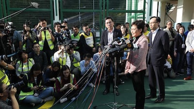 Chief Executive Carrie Lam speaks to media after casting her vote. EPA
