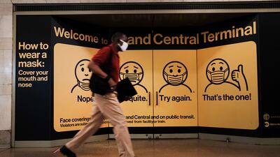 A person wears a mask while walking in Grand Central Terminal in New York City. Getty Images