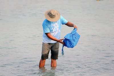 The clean-up operation was not limited to land, with volunteers taking to the sea to retrieve waste at Zero Gravity. Satish Kumar / The National