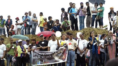 People pray at the massacre site last month.