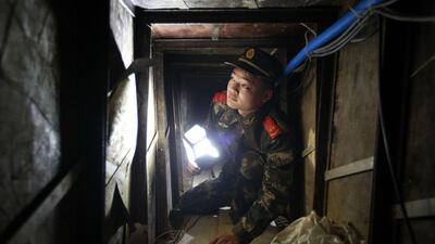 A Chinese soldier in the 40-metre tunnel from Shenzhen, in south China, to Hong Kong, where differing trade tariffs make smuggling lucrative. AFP