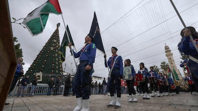 Palestinian scouts march during a ceremony at Bethlehem's Church of the Nativity. AFP