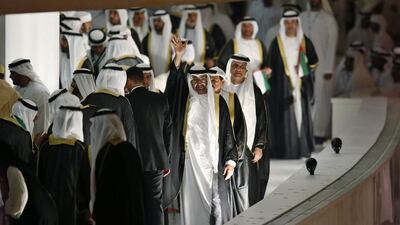 Sheikh Mohammed bin Zayed, Crown Prince of Abu Dhabi and Deputy Supreme Commander of the Armed Forces, centre, waves to the crowd at the Zayed Sports Stadium in Abu Dhabi. EPA /Ali Haider