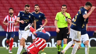 Atletico Madrid midfielder Joao Felix takes a fall. AFP