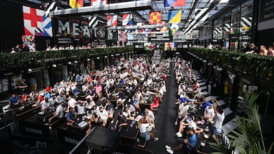 England supporters cheer while watching the England-Croatia match on a big screen in Boxpark, Croydon. EPA