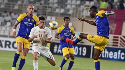 Al Wahda's Tagliabue fights for the ball with Al Nassr's Omar Hawsawi. AFP