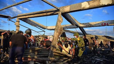 Firefighters, rescuers and survivors search for bodies. 53 people remained missing. Ronaldo Schemidt / AFP Photo