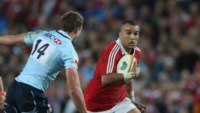 Simon Zebo, of the Lions, moves past Cam Crawford during the match. David Rogers / Getty Images