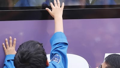 His sons and daughter shared a final moment together, pressing their hands against the class of the bus before the crew left for the launchpad. EPA