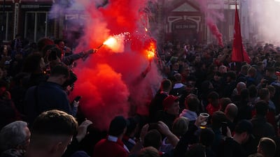 Liverpool fans greet their team bus. PA