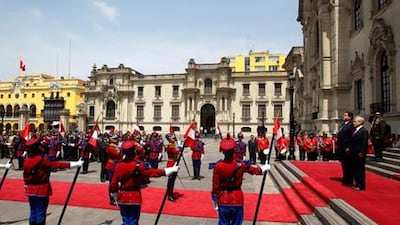 A guard of honour salutes the Peruvian president Alan Garcia, left, and his visiting Chilean counterpart, Sebastian Pinera, as Peru’s national anthem is played during a state ceremony in Lima.