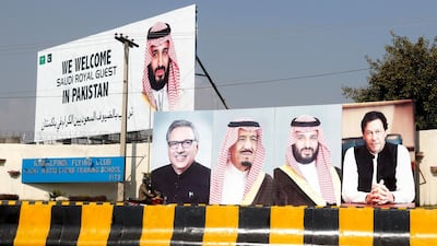 Billboards showing Arif Alvi, President of Pakistan, Mohammad Bin Salman and Pakistani Prime Minister Imran Khan, are displayed on roads in Islamabad. EPA