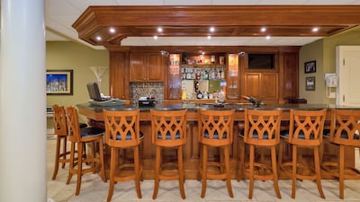 The mahogany bar. Courtesy Douglas Elliman Realty
