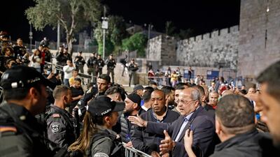Israeli Arab politician Ahmad Tibi speaks to members of the Israeli security forces as Palestinian protesters gather at the Damascus Gate in Jerusalem's Old City. AFP