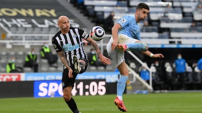 Manchester City's Spanish midfielder Ferran Torres (R) back heels the ball to scores his team's second goal in the 4-3 win at Newcastle. AFP