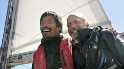 Mitsuhiro Iwamoto celebrates with his navigator Doug Smith after successfully completing a near two-month, non-stop voyage from San Diego to Fukushima. Reuters