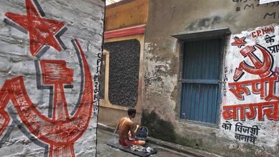 A man bathes in an alley in Kolkata earlier this year, daubed with symbols of the Communist Party of India (Marxist), but poor results in this year’s parliamentary elections have called into question the party’s relevance in today’s market-led economy. Rupak De Chowdhuri / Reuters
