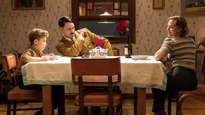 Roman Griffin Davis, Taika Waititi and Scarlett Johansson in a scene from 'Jojo Rabbit'.