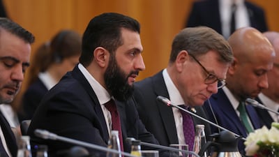 Mr Al Shara gives an opening statement as he sits next to German Foreign Minister Johann Wadephul, at a German-Syrian economic roundtable at the Foreign Ministry in Berlin. Getty Images