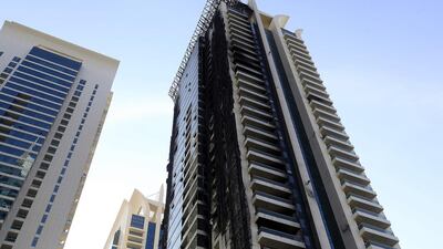 Fire devastated Tamweel Tower in Jumeirah Lakes Towers last November, leaving hundreds homeless, but repair work has yet to begin and owners are forced to keep paying for rented homes. Satish Kumar / The National