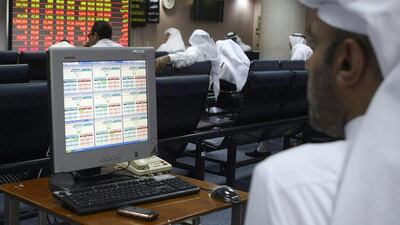Investors monitor stock market activities at the Qatar Exchange. Reuters