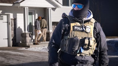 ICE agents look for someone at a home on Wednesday in Circle Pines, Minnesota. After two fatal shootings by federal agents in the state, US President Donald Trump appears to have flinched. AFP