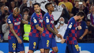 (L to R) Barcelona's Chilean midfielder Arturo Vidal, Barcelona's Uruguayan forward Luis Suarez and Barcelona's Portuguese defender Nelson Semedo celebrate Barcelona's Argentine forward Lionel Messi's second goal during the Spanish league football match between FC Barcelona and Real Valladolid FC at the Camp Nou stadium in Barcelona on October 29, 2019. / AFP / LLUIS GENE