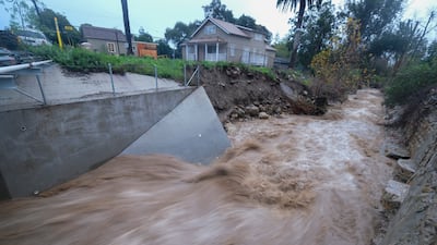 Water rages along Montecito Creek in in Montecito. AP