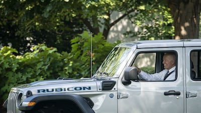 US President Joe Biden drives an electric Jeep Wrangler Rubicon at the White House in August 2021. Bloomberg